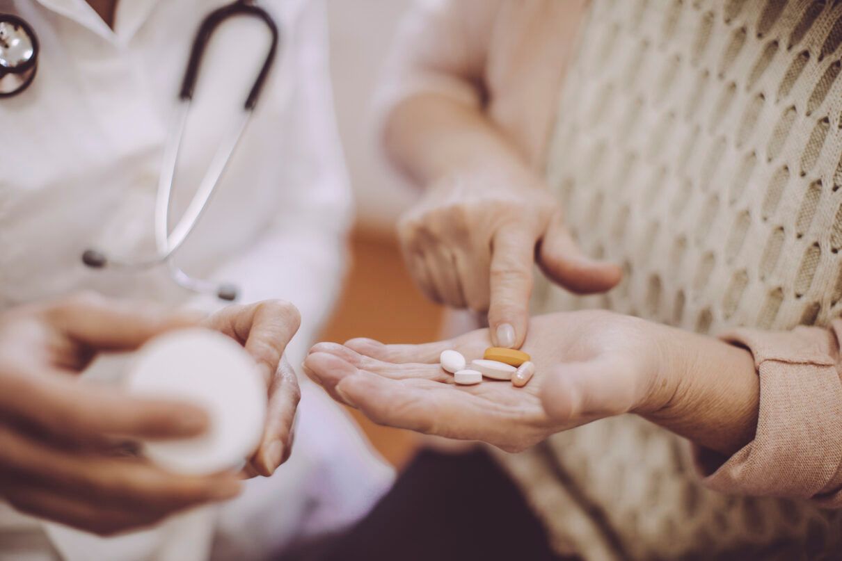 a doctor giving a woman Prescription Medication