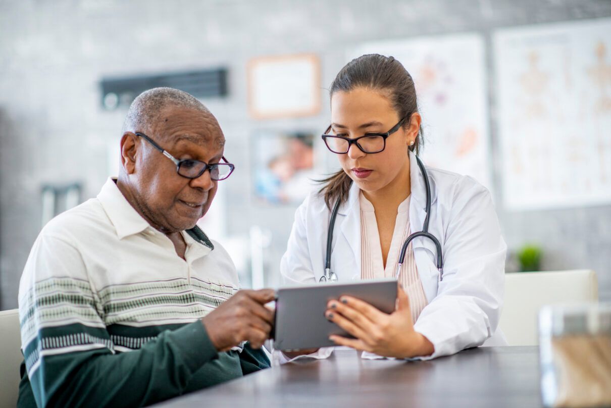 a senior man having his medical test results explained by a doctor
