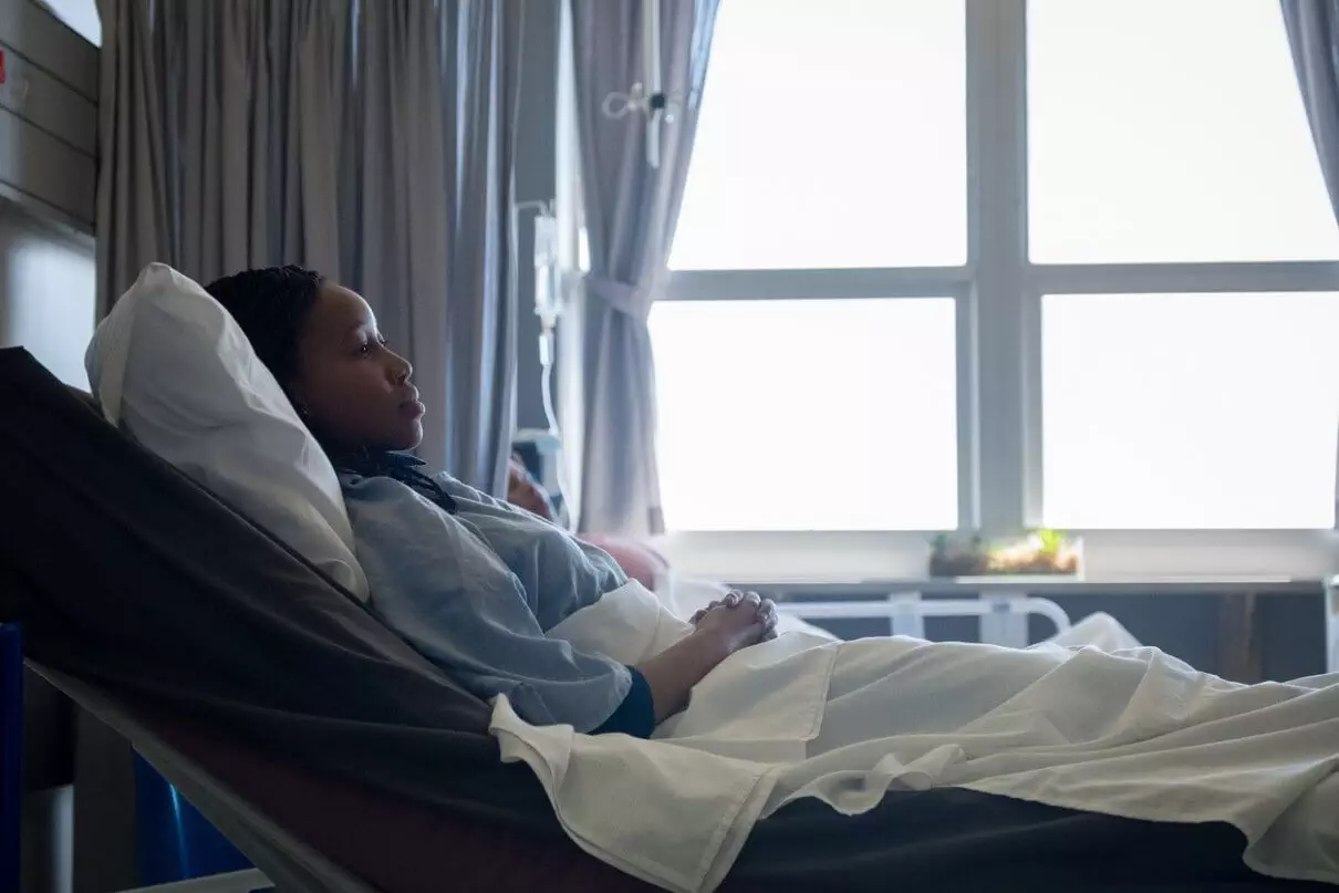 woman with sepsis laying in a hospital bed