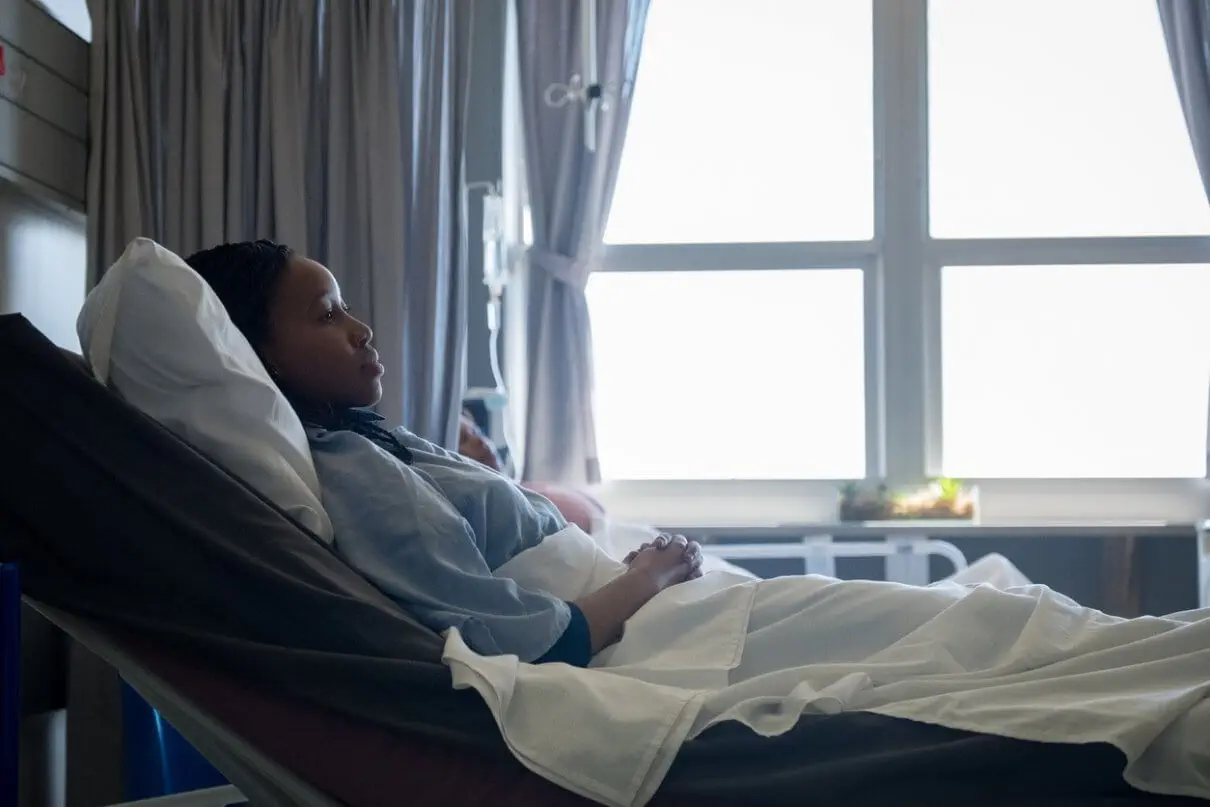 woman with sepsis laying in a hospital bed