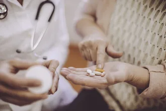 a doctor giving a woman Prescription Medication