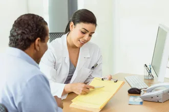 a doctor having a patient sign medical consent forms